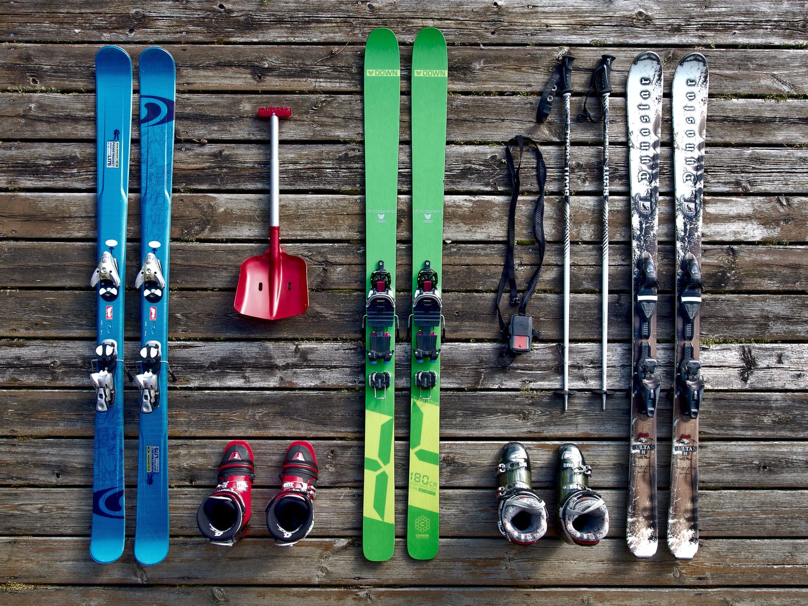Skis, poles and ski boots laid out on wooden boards ready for packing
